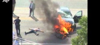 Burning+car+lifted+off+trapped+man.