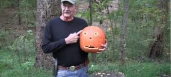 Carving+a+pumpkin+with+a+handgun.