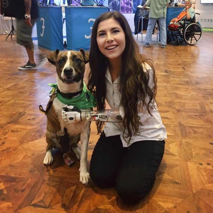 Amputee+girl+and+dog+at+a+prosthetic+technology+conference