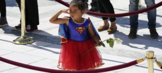 A+girl+wearing+a+Supergirl+costume+pays+respects+at+RBG%26%238217%3Bs+casket.