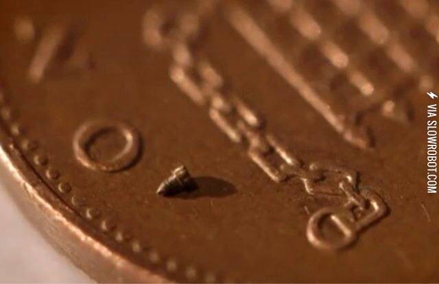 A+screw+used+in+watch+making+resting+on+a+British+penny.