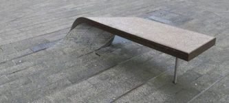 This+paving+stone+curls+into+a+bench+to+sit+on