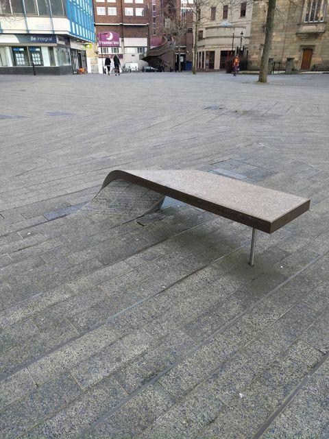 This+paving+stone+curls+into+a+bench+to+sit+on