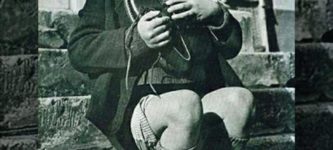 Orphaned+boy+showing+immense+joy+on+receiving+new+pair+shoes+as+a+birthday+gift+1946