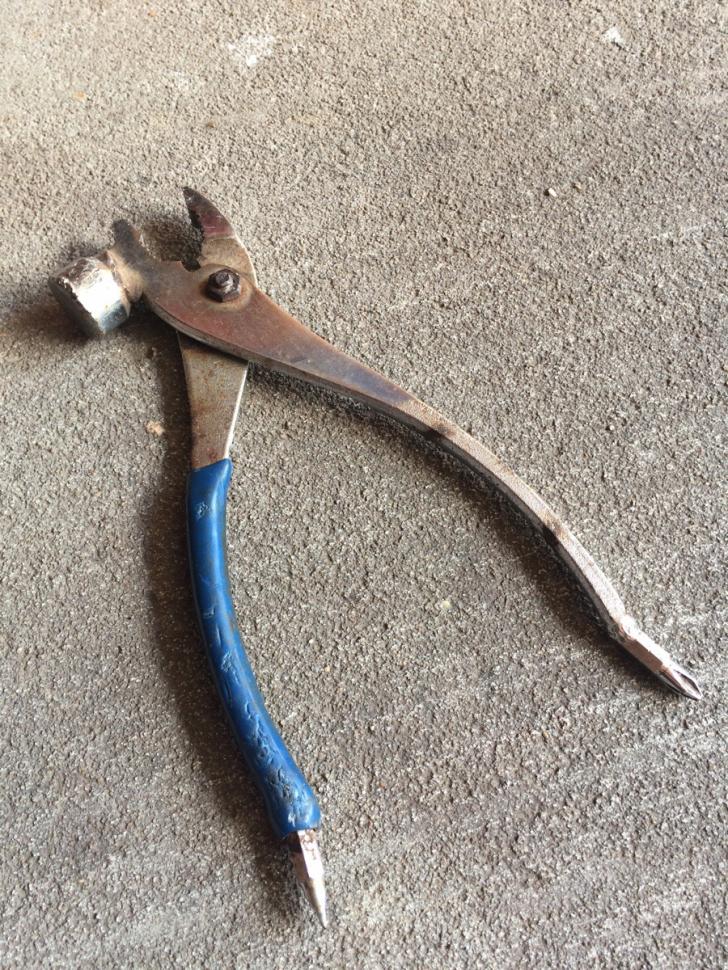 My+grandfathers+pair+of+pliers+has+a+hammerhead+and+two+screwdrivers+attached+to+it