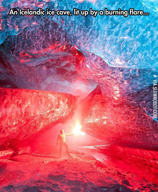 An+Icelandic+ice+cave%2C+lit+up+by+a+burning+flare