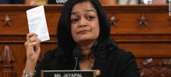 U.S.+Representative+Pramila+Jayapal+held+up+a+copy+of+the+Constitution+as+she+voted+to+impeach.