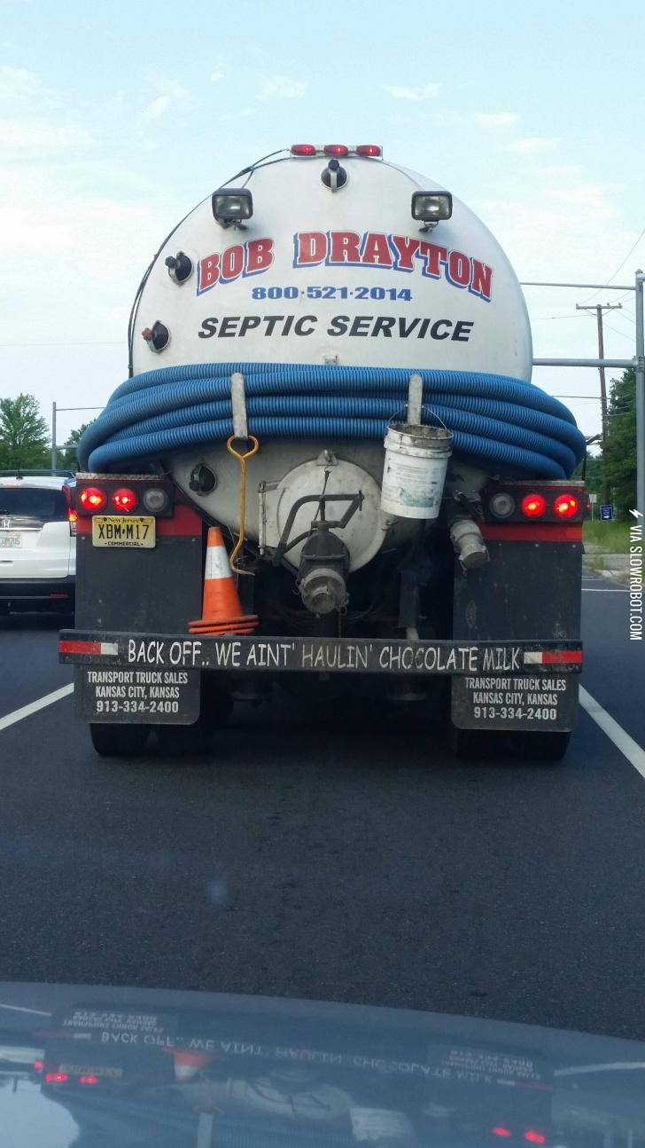 Tailgate+warning+on+a+truck+hauling+septic+waste.