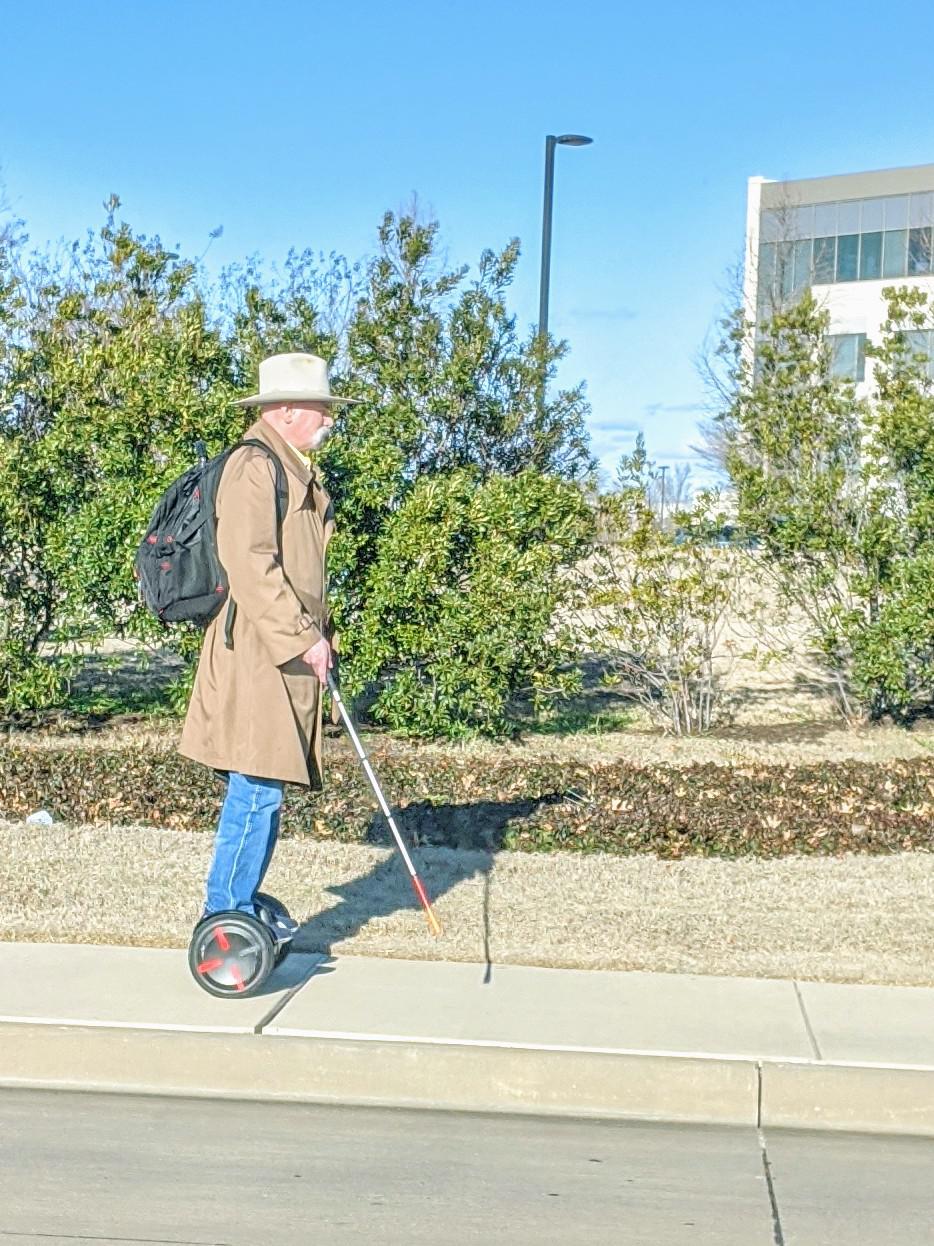 Blind+cowboy+commutes+on+a+hover+board.