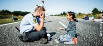 Danish+police+officer+playing+%26quot%3Bpeek+a+boo%26quot%3B+with+a+young+refugee+girl