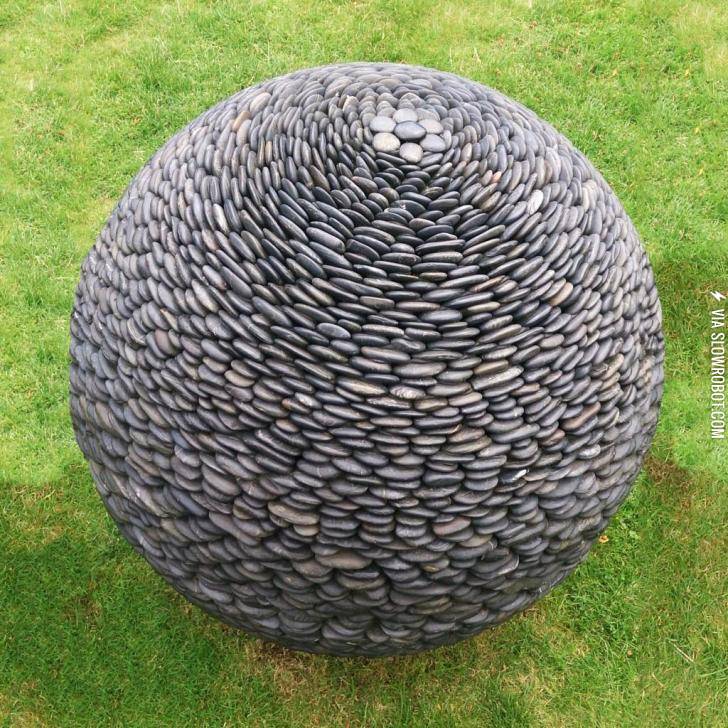 Sphere-shaped+sculpture+made+of+pebbles.