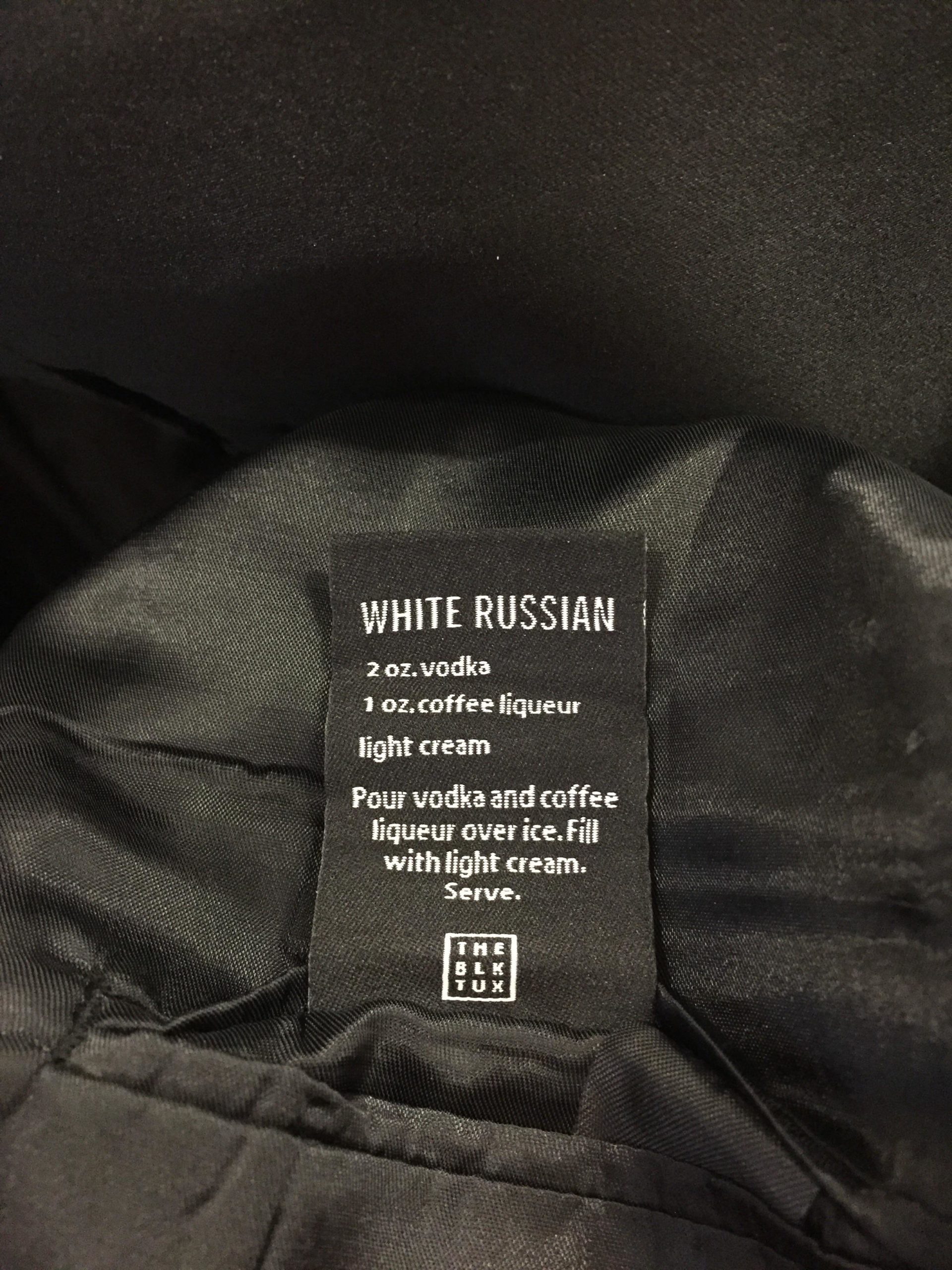 A+tuxedo+with+a+drink+recipe+on+its+tag.