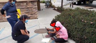 Two+girls+sit+outside+a+Taco+Bell+in+Salinas%2C+CA+for+access+to+free+wi-fi+to+attend+school+online