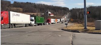 Line+of+trucks+waiting+outside+a+toilet+paper+and+paper+towel+factory+to+be+loaded.