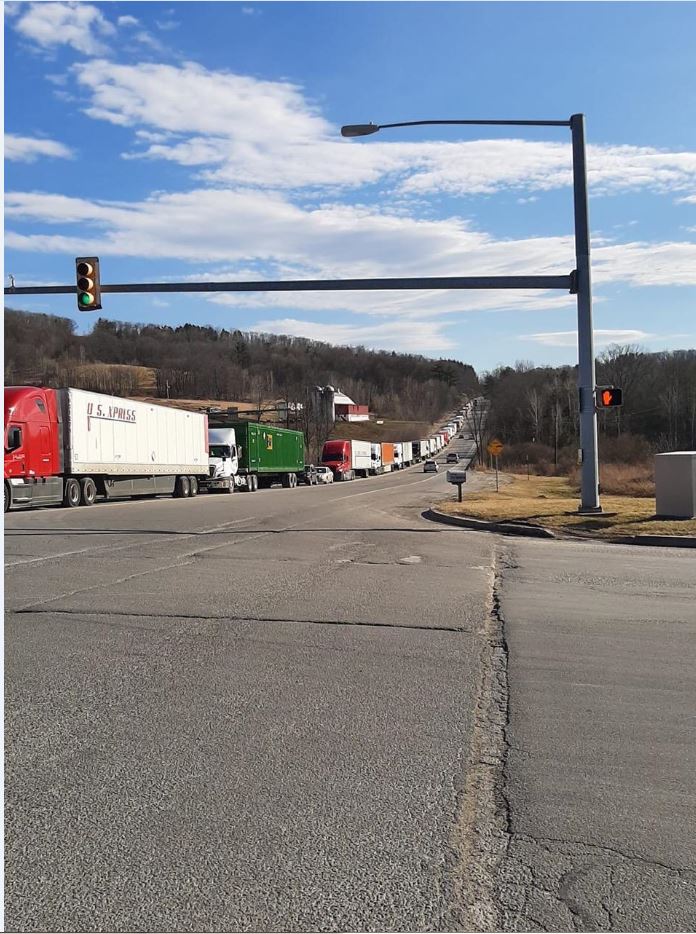 Line+of+trucks+waiting+outside+a+toilet+paper+and+paper+towel+factory+to+be+loaded.